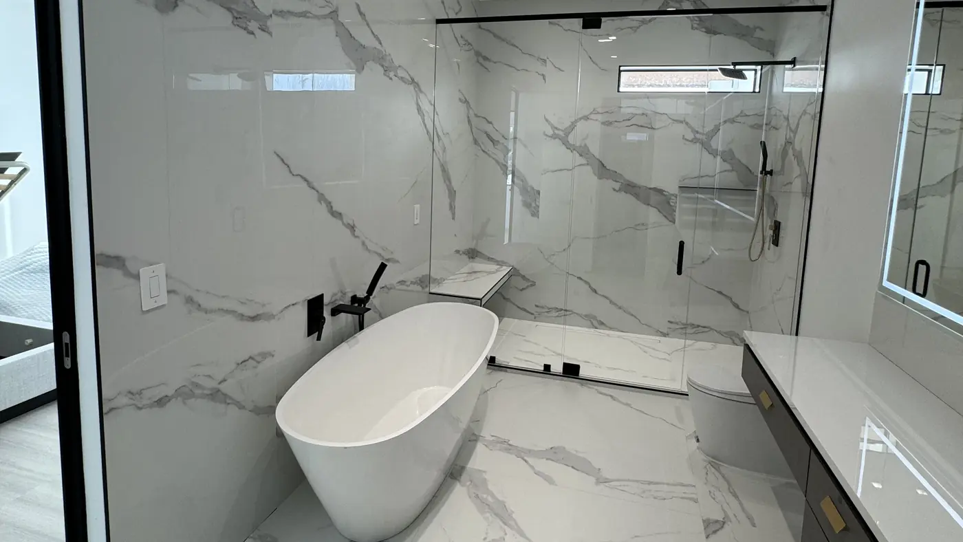 Master bathroom remodel with a freestanding tub, marble-look walk-in shower and vanity