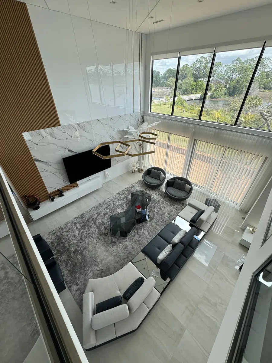 Bright living room with new light flooring and floor-to-ceiling windows