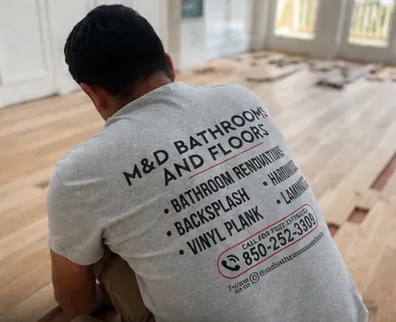 M&D crew member installing hardwood flooring